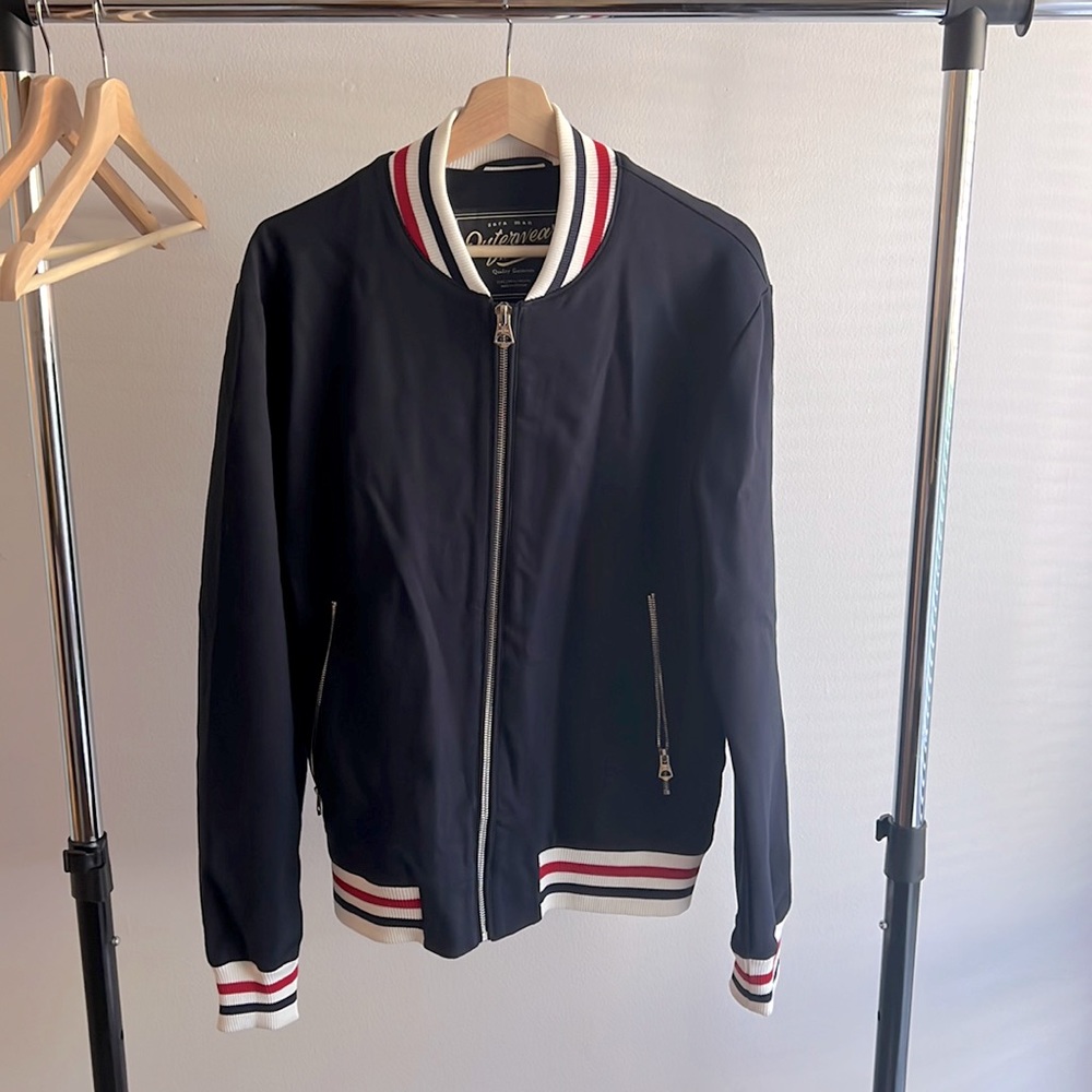 This is a Zara Men’s Navy Blue Track Jacket. Worn Twice. Like new condition.